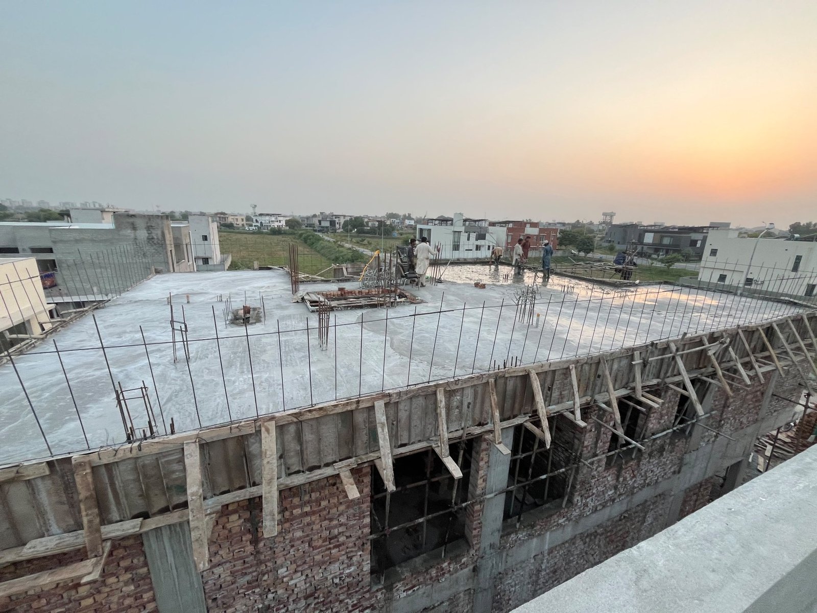 Wide view of concrete slab and reinforcement at a construction site