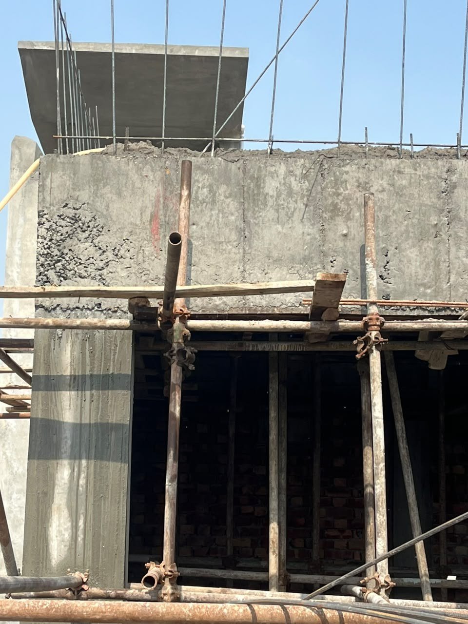 Client-supplied construction photograph showing structural work and scaffolding